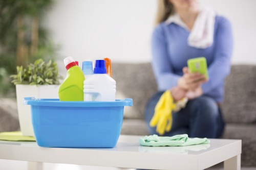 Technician using upholstery cleaning equipment on a couch